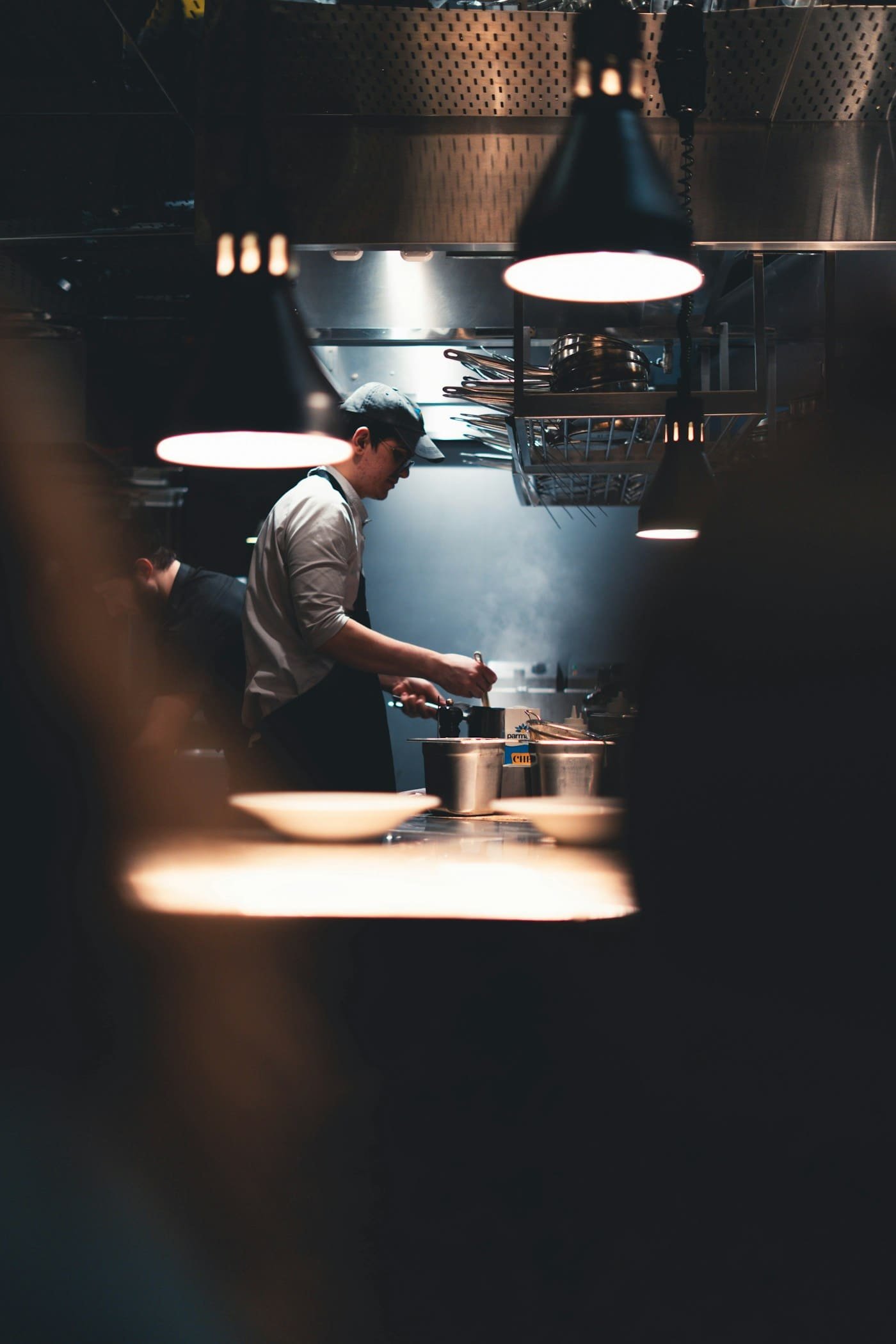 A chef working through service in a busy professional kitchen