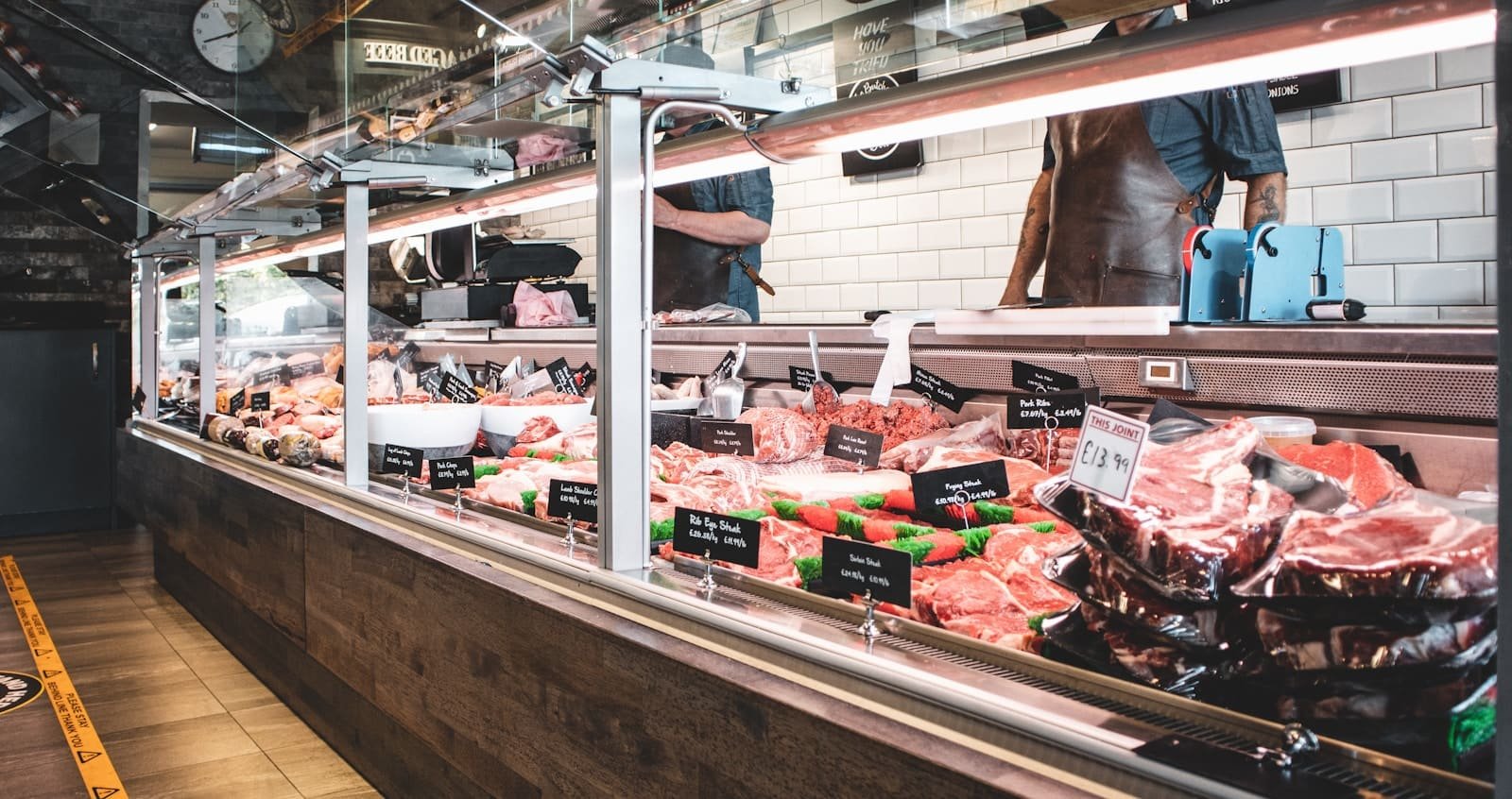Trays of fresh meat laid out on a butcher's counter