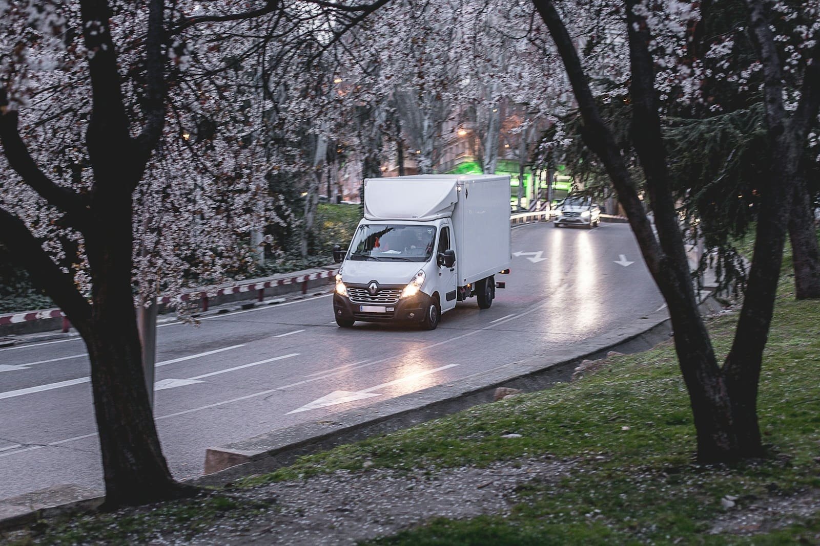 A white delivery van on the road